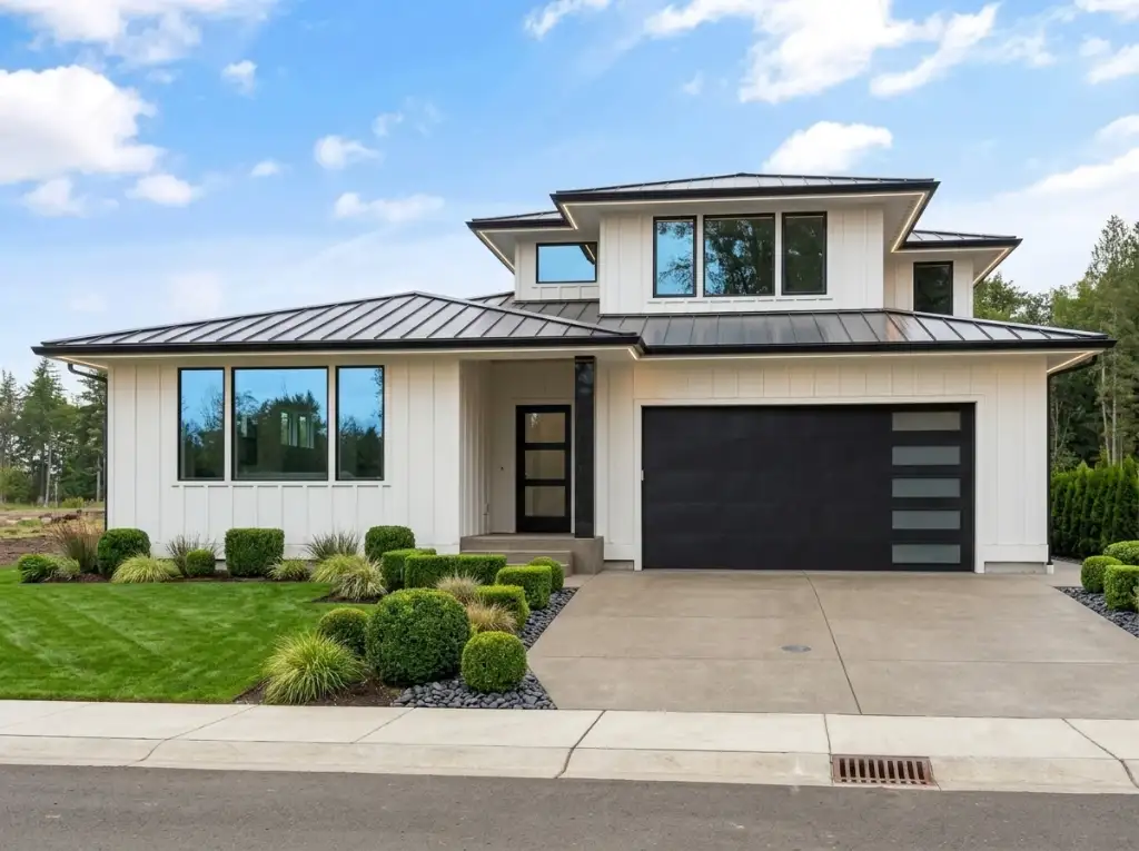 Plan 280263JWD in white board-and-batten with a dark standing-seam metal roof, a black garage door with frosted lites and clipped boxwood