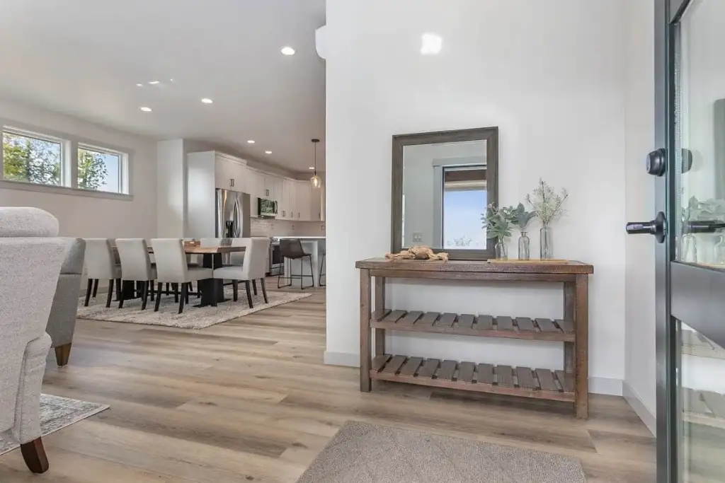 Entry of plan 280263JWD with a console table, mirror and a clear sightline through to the dining area and kitchen