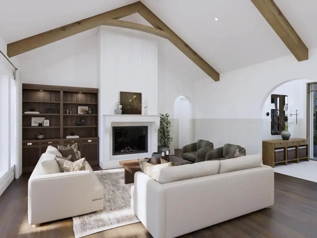 Great room fireplace with a plaster surround and flanking walnut built-in shelving under a vaulted, timber-beamed ceiling