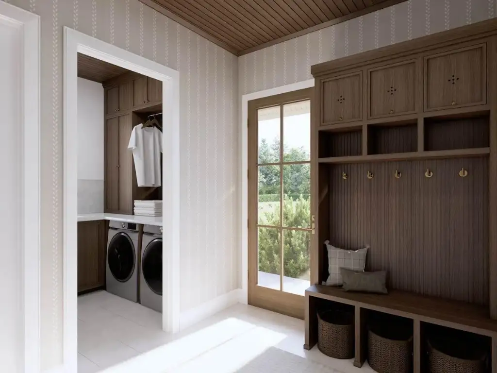 Mudroom with oak lockers, a bench, brass hooks and a side entry, open through to the laundry room