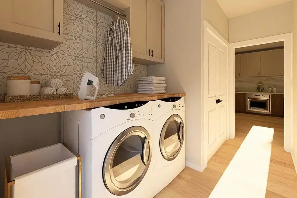 Kitchen detail showing shaker cabinets, pendant trio, and quartz countertop
