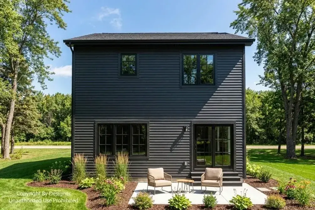 Angled exterior view of two-story modern farmhouse with covered front porch, black-framed windows, and contemporary garage door