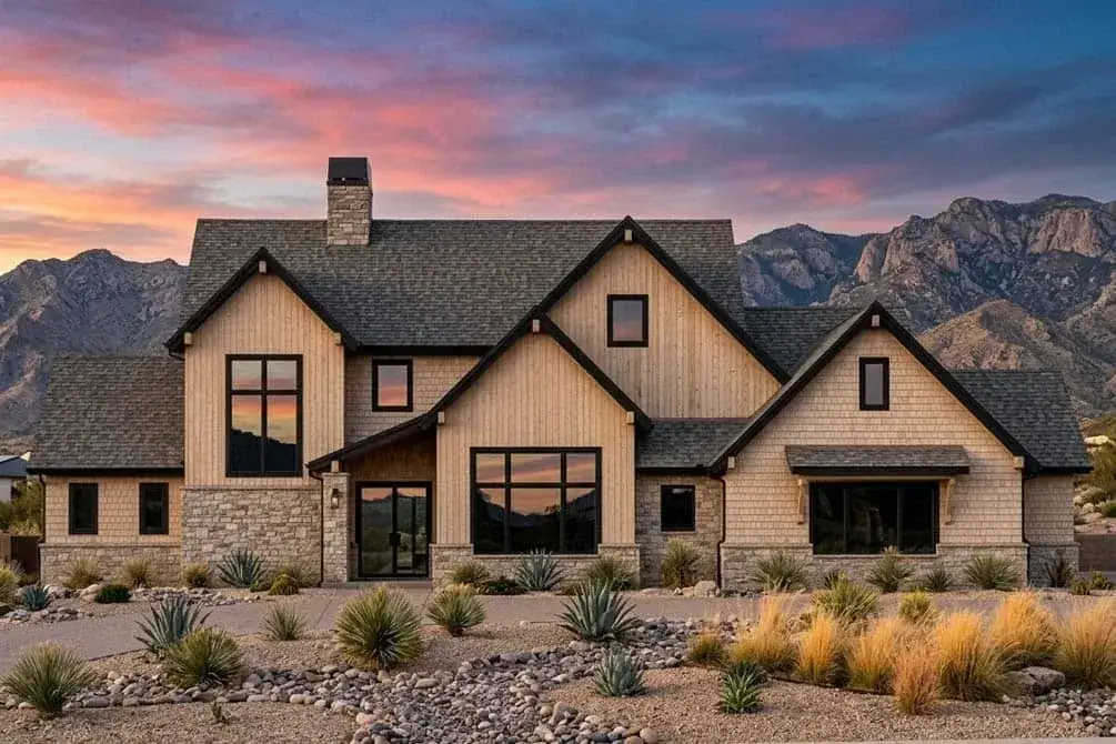 Evening view of the farmhouse with warm window light and stone veneer base