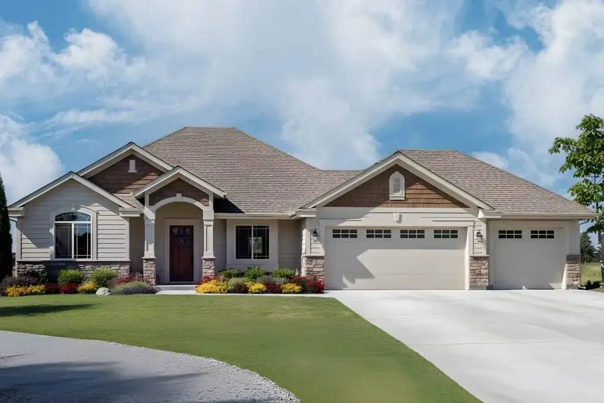 Three-quarter view of plan 267115SPK with carriage-style three-car garage and stone-and-shake Craftsman facade